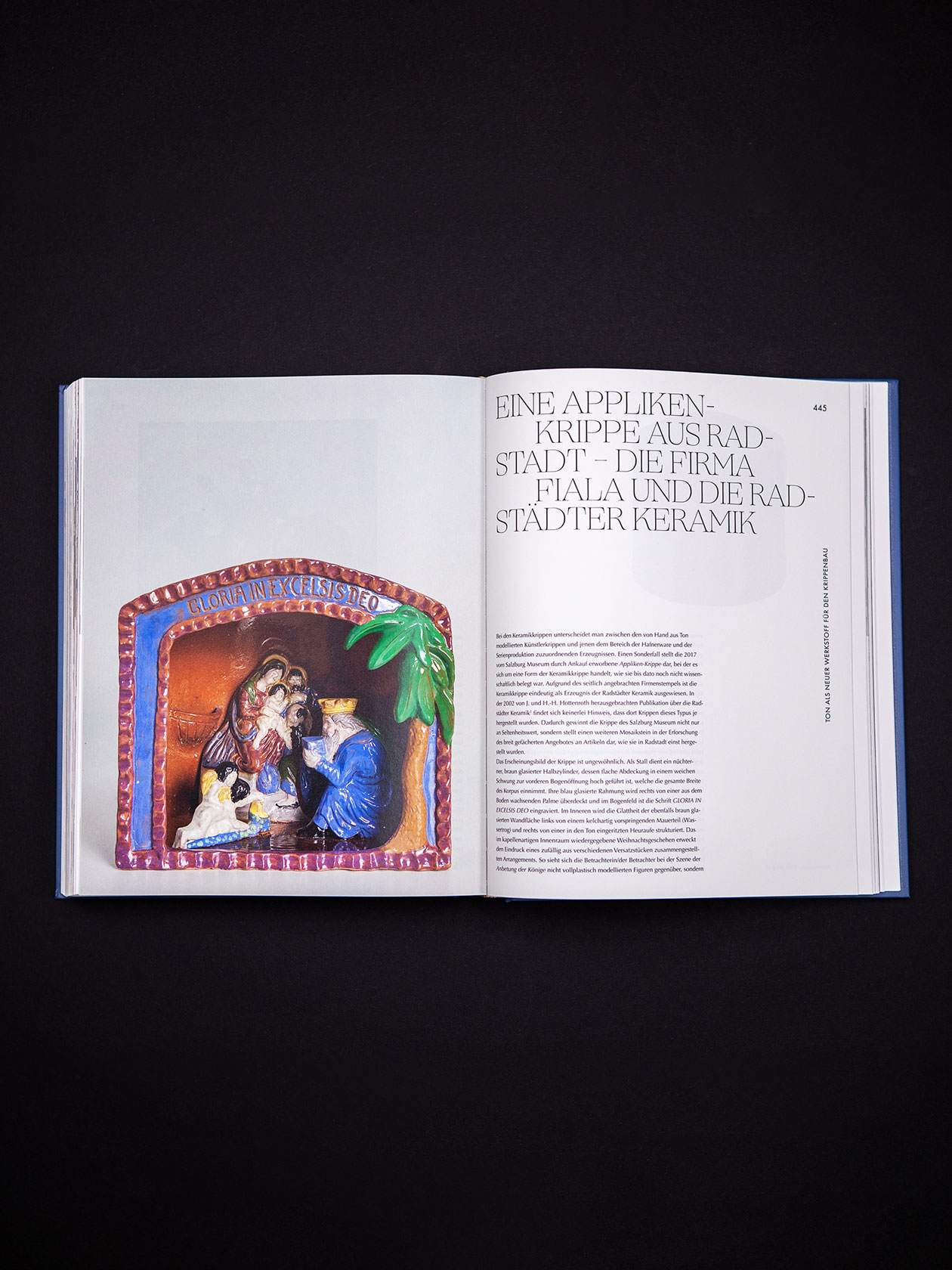 Book spread with a nativity-scene photograph and designed typography