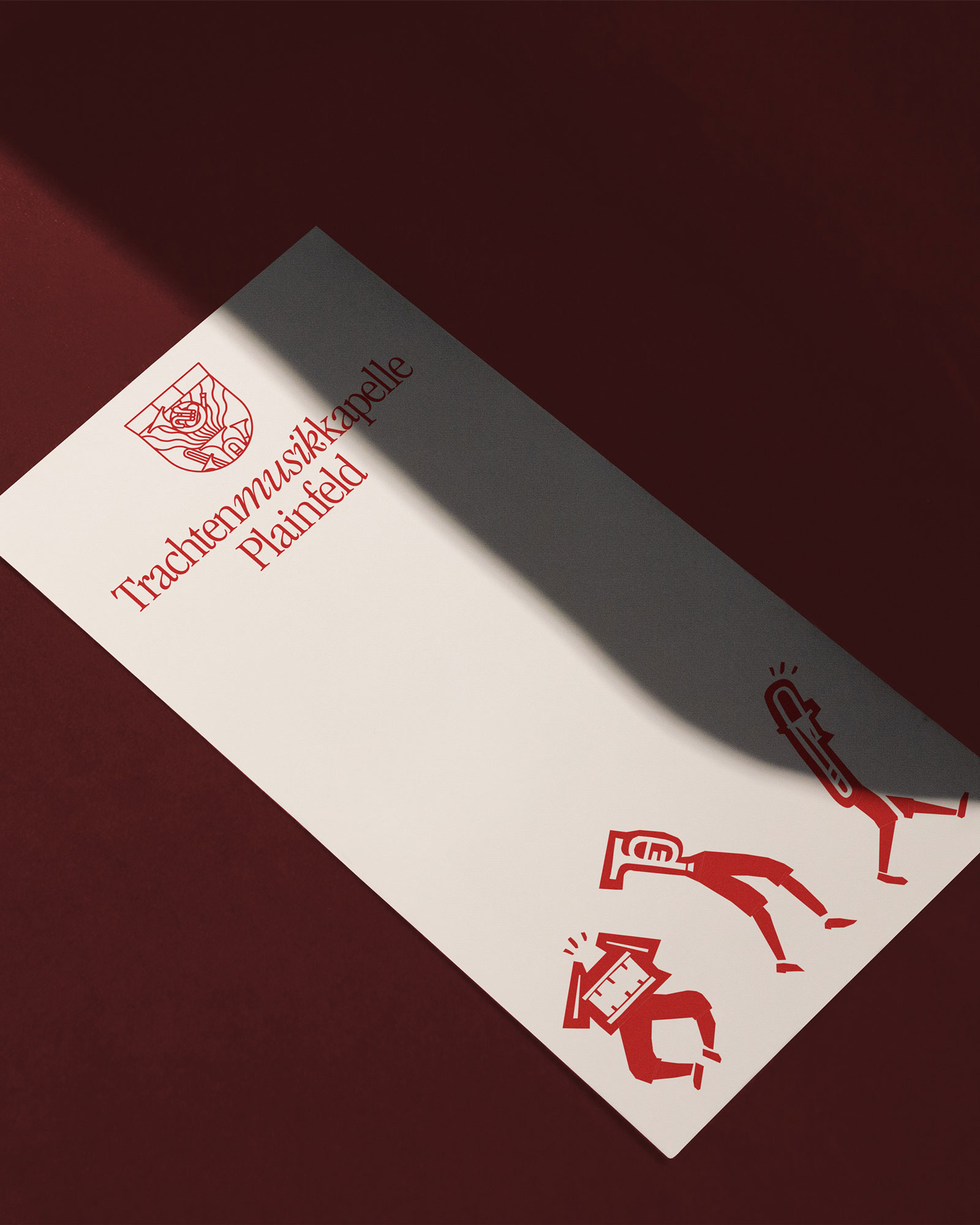 Slim white leaflet with red typography, a crest and musician characters
