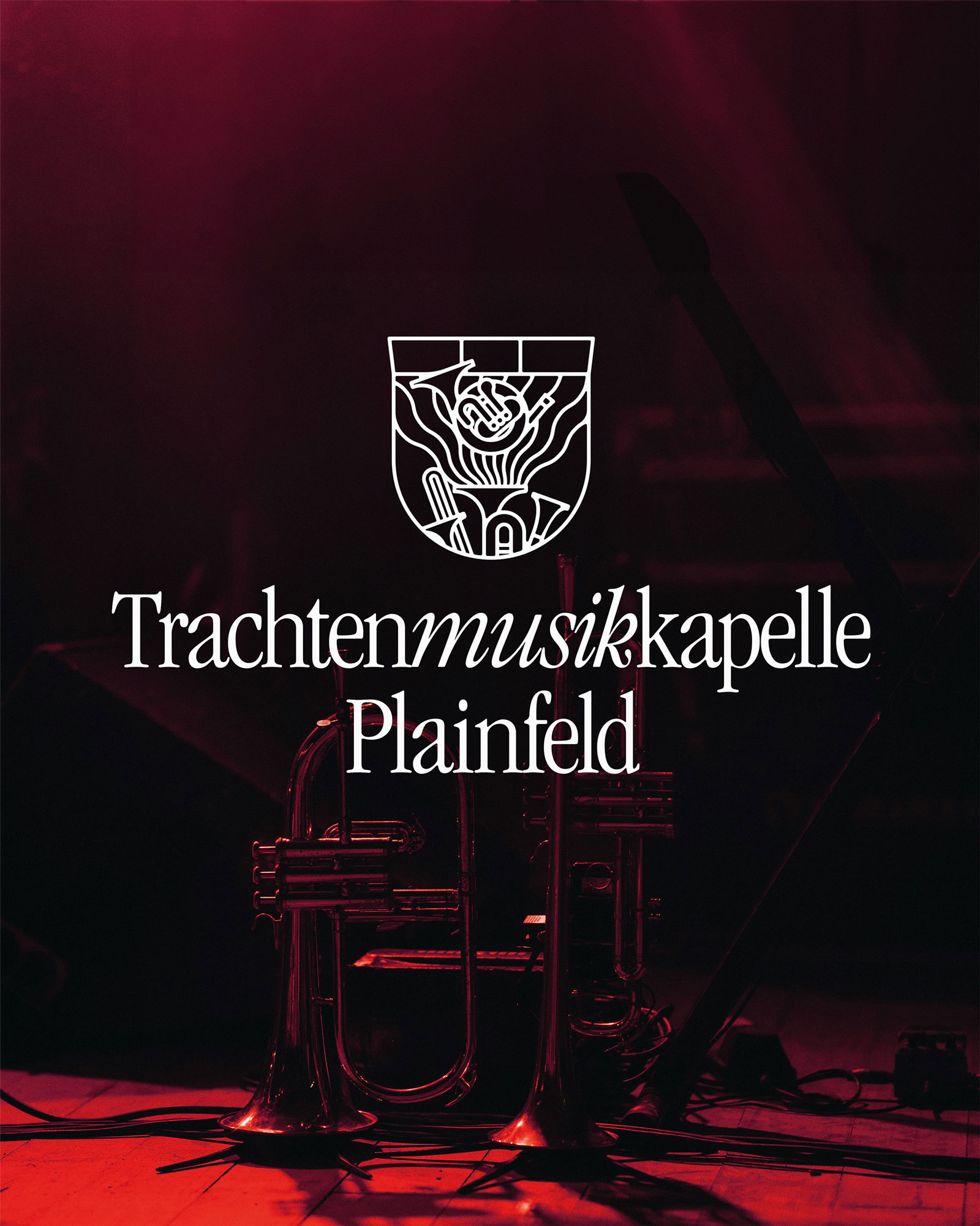 White crest and Trachtenmusikkapelle Plainfeld wordmark over a tuba photograph