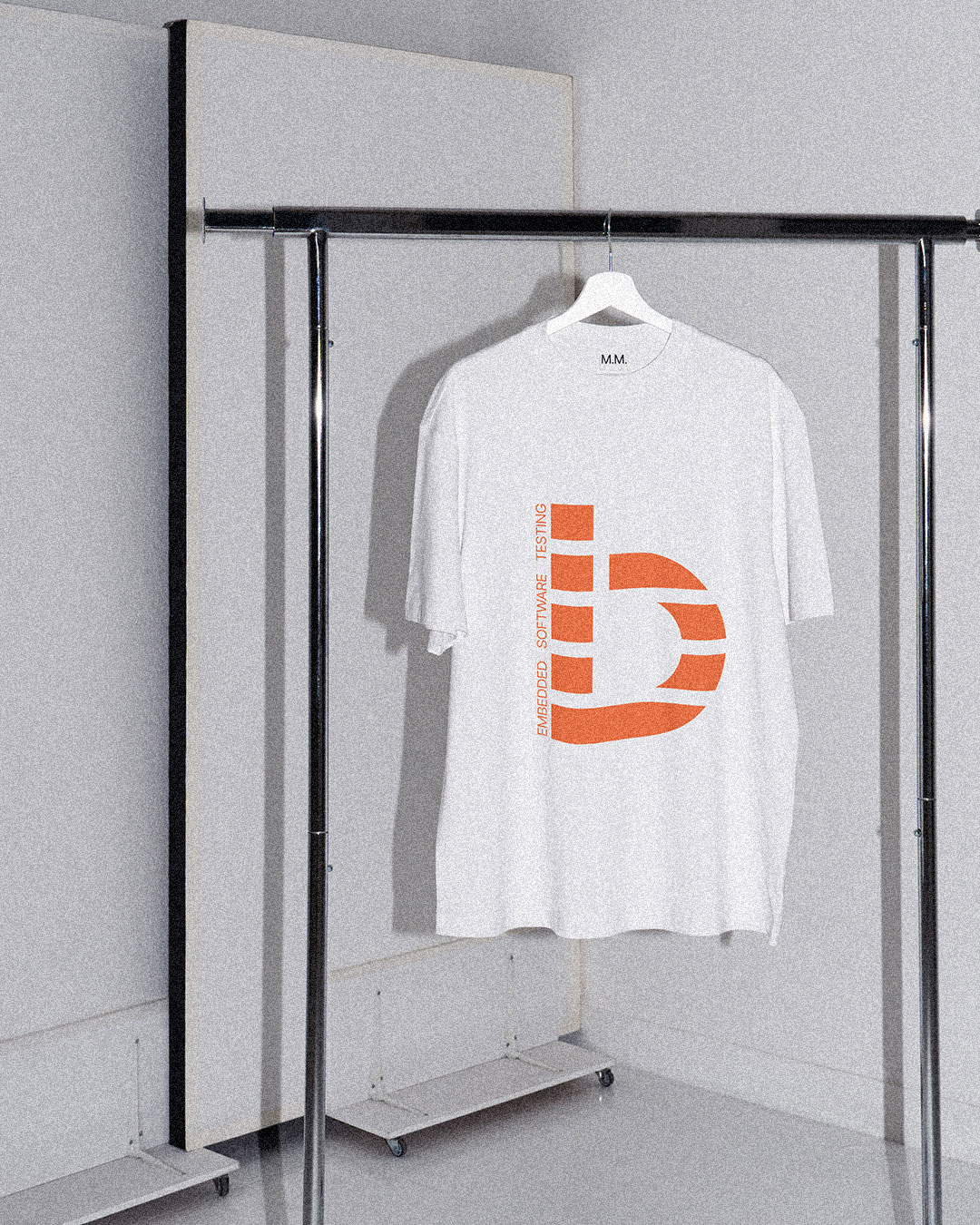 White T-shirt with an orange bitcrush symbol on a hanger