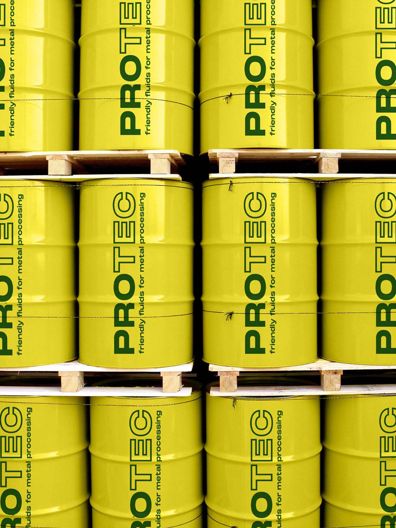Yellow PROTEC industrial drums with green vertical lettering