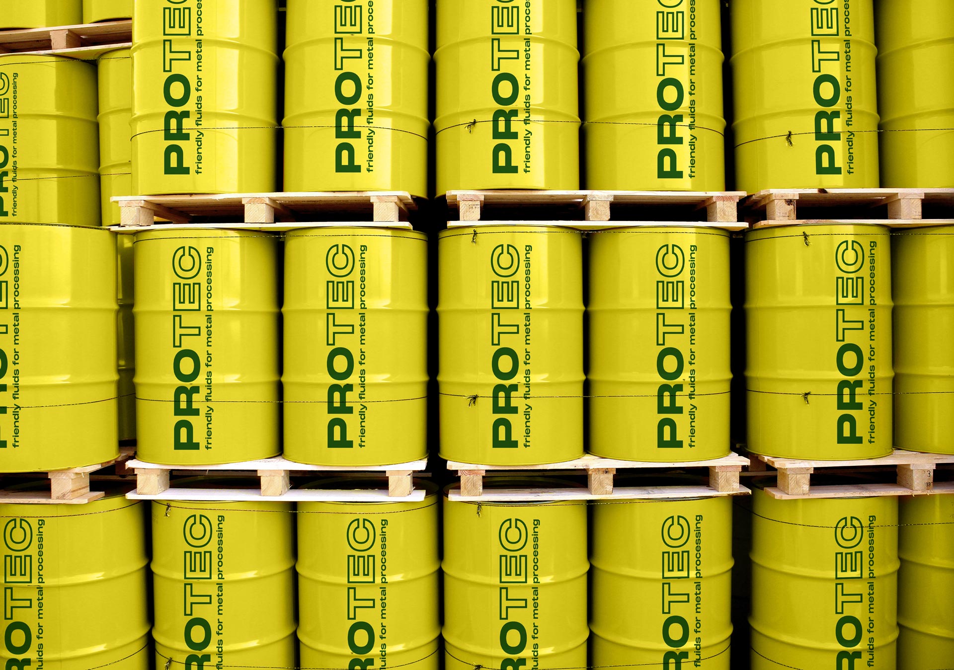 Stacked yellow PROTEC drums on pallets