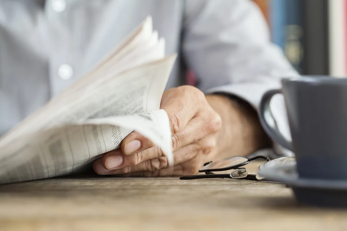 Person reading a newspaper