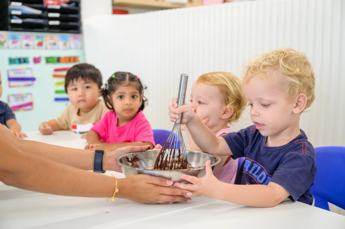 Children listening to a teacher reading a French story