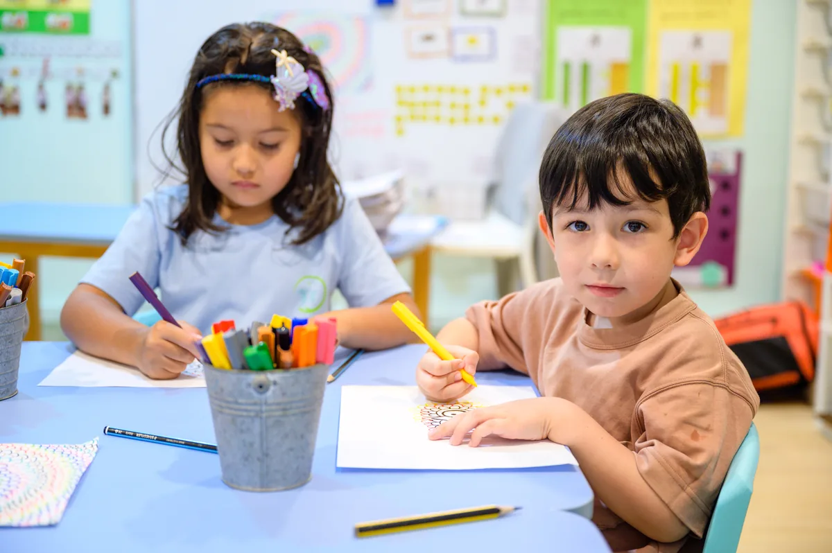 Children working in small groups in a French preschool classroom