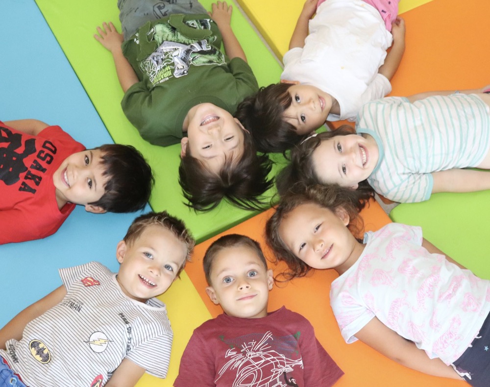 Children lying in a circle