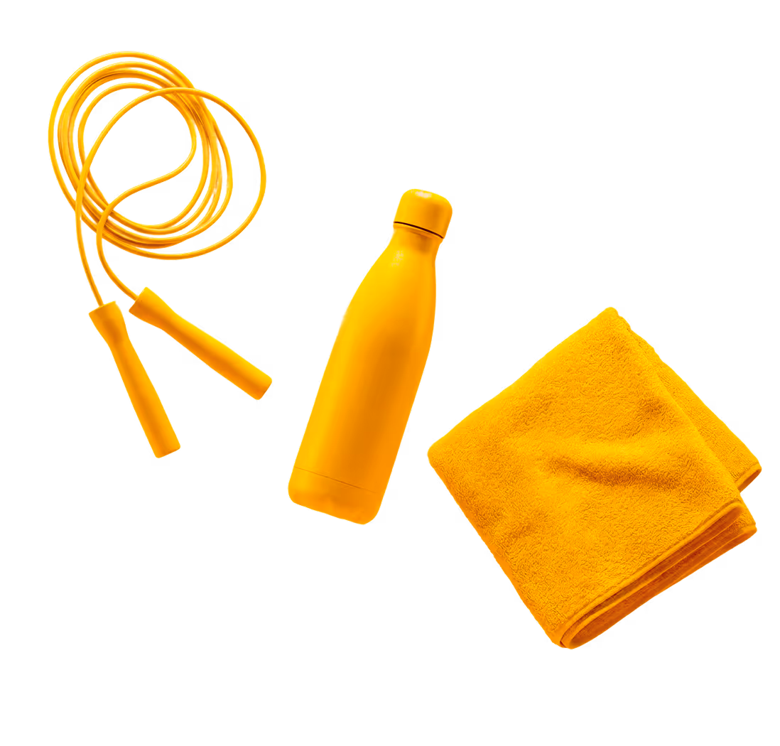 Yellow jump rope, water bottle, and folded towel on a black background.