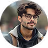 Homme portant des lunettes et une veste noire souriant légèrement devant un fond flou.