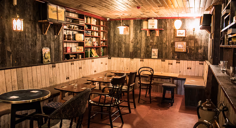 Reclaimed timber snug lined with vintage shop shelving at Mary's Bar & Hardware