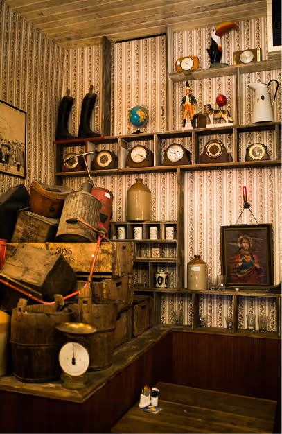 Shelves of vintage clocks, stoneware jars and wooden crates in the hardware-shop corner at Mary's Bar & Hardware