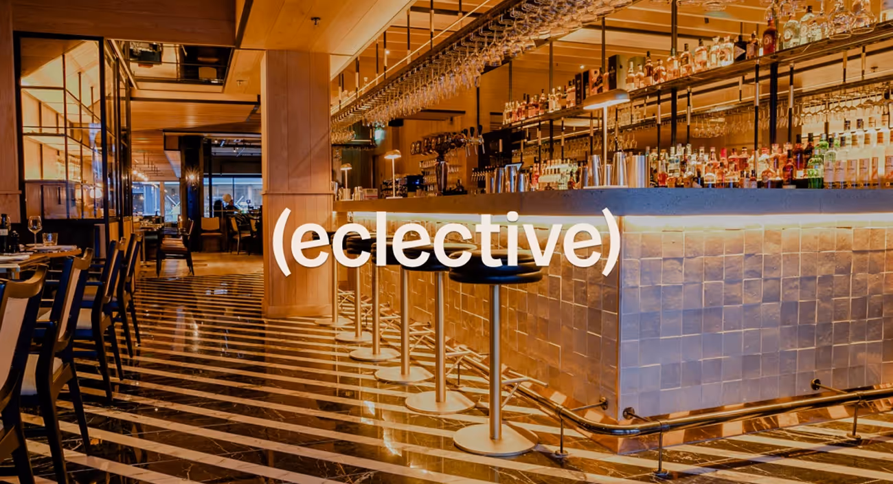 Eclective Hospitality logo over a tiled bar with a striped marble floor