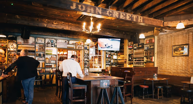 John Creeth signage above the bar and haberdashery display cases at John's Bar & Haberdashery