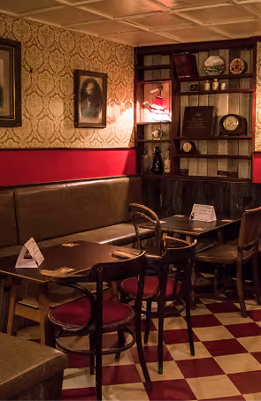 Mary's Bar & Hardware dining area with checkered floor and eclectic vintage decor