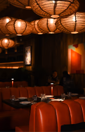 Kaldero restaurant interior with red booth seating and moody dim lighting