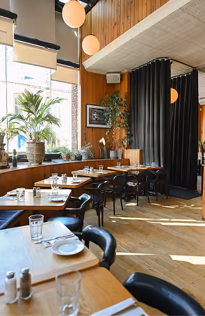 Elephant & Castle dining room with white tablecloths and classic bistro-style seating