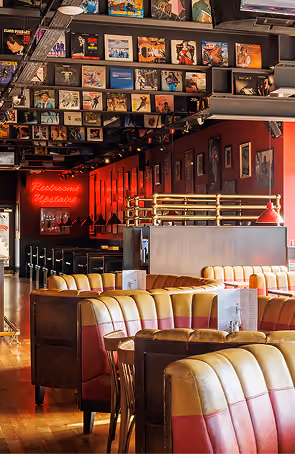 Captain Americas' memorabilia-covered walls and red booth seating in a lively dining space