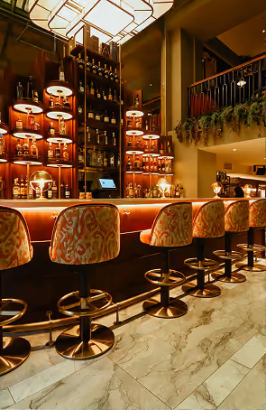 The Stapleton's multi-level bar with bottle display shelving and bar stool seating