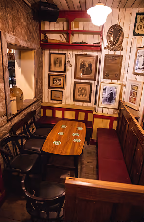 John's Bar & Haberdashery dining room decorated with vintage framed prints