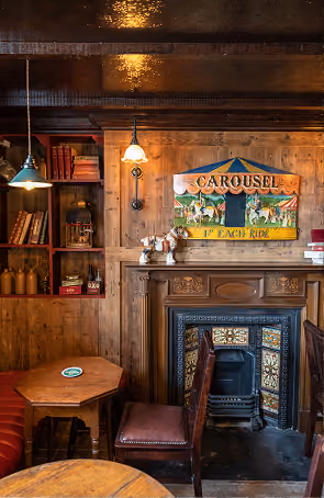 Foxhunter's cozy pub corner with fireplace and traditional wooden furnishings