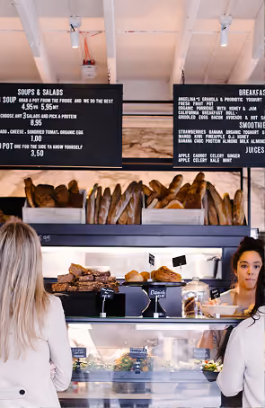 Angelina's Deli counter display with staff serving fresh food items