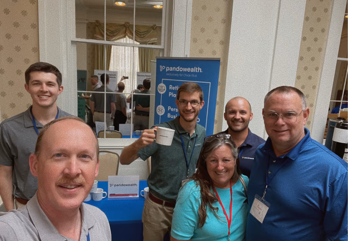a selfie photo of the Pandowealth team at a trade booth