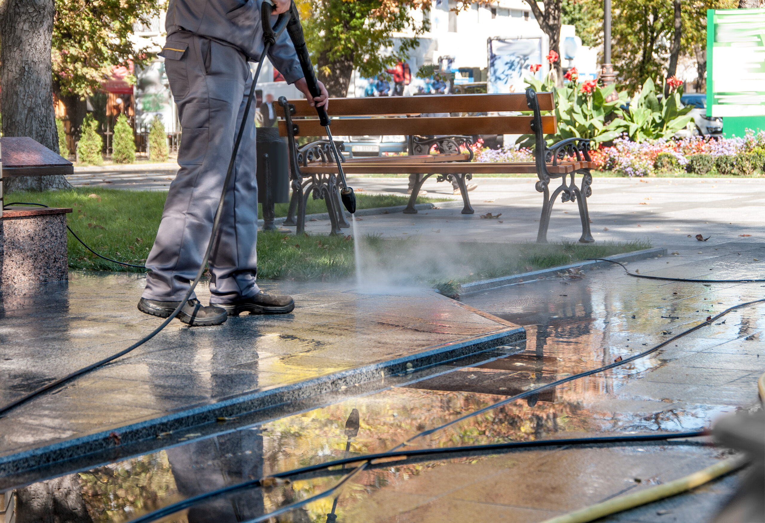 Cleaning dirty streets with high pressure cleaner