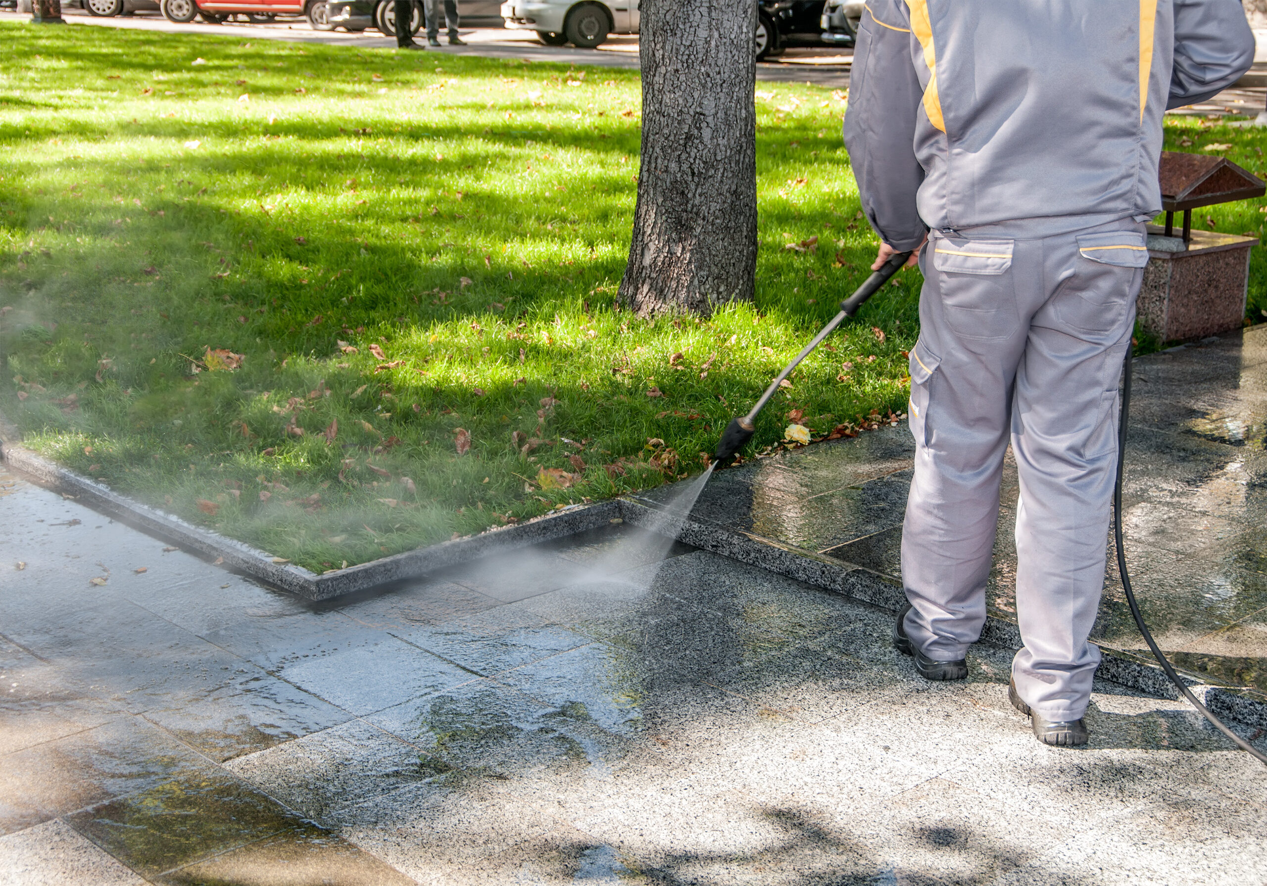 Cleaning dirty streets with high pressure cleaner