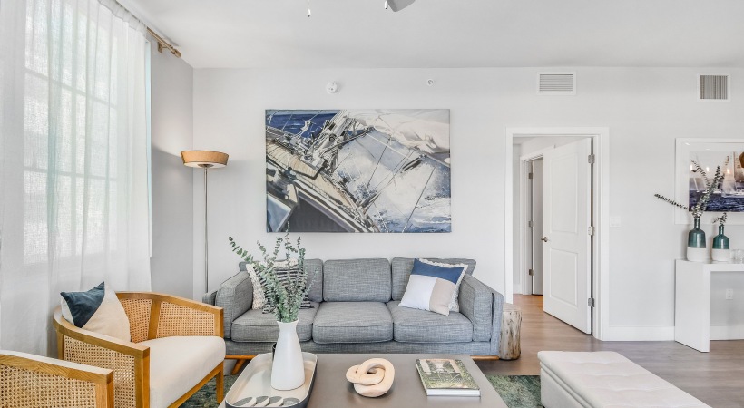 Living Room with blue couch and brown modern chairs