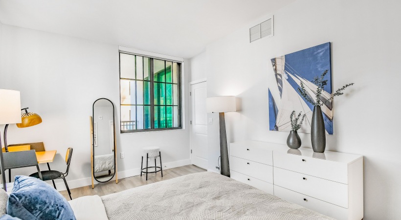 Bedroom with bed dresser and window