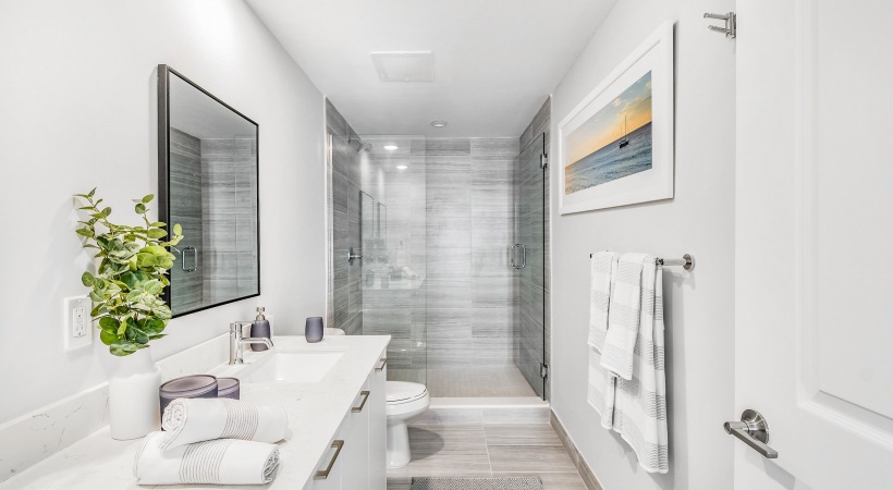 bright white Bathroom with walk in sgrey tiled hower