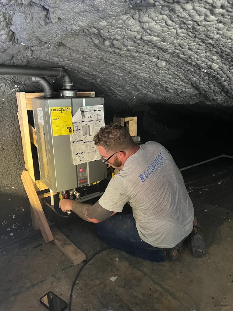 plumber installing tankless water heater