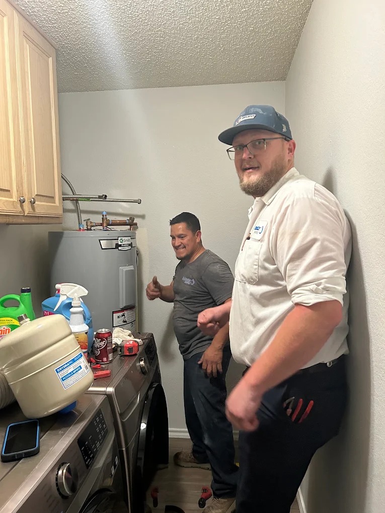 plumbers servicing a water heater