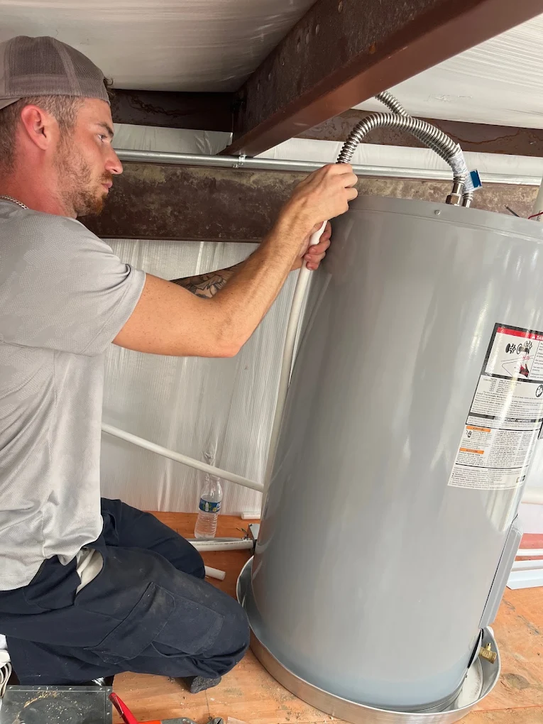 plumber replacing water heater unit