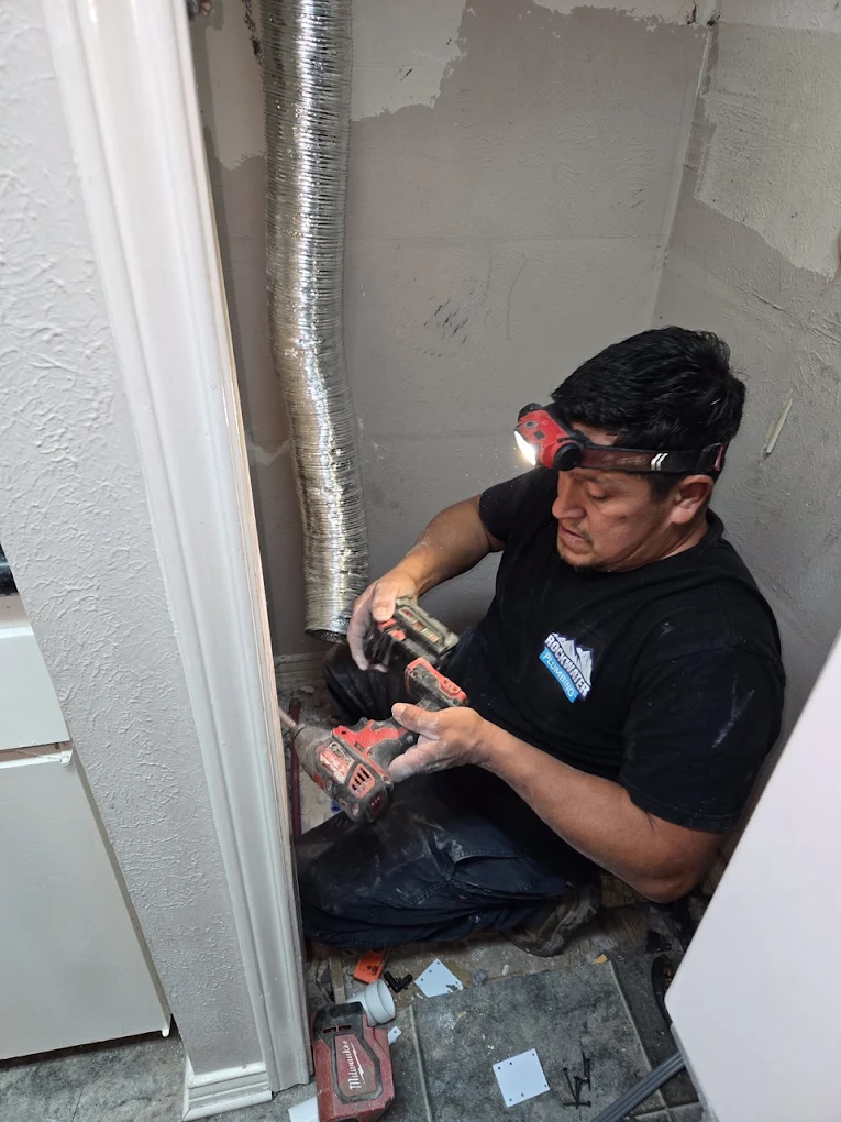 plumber repairing a pipe