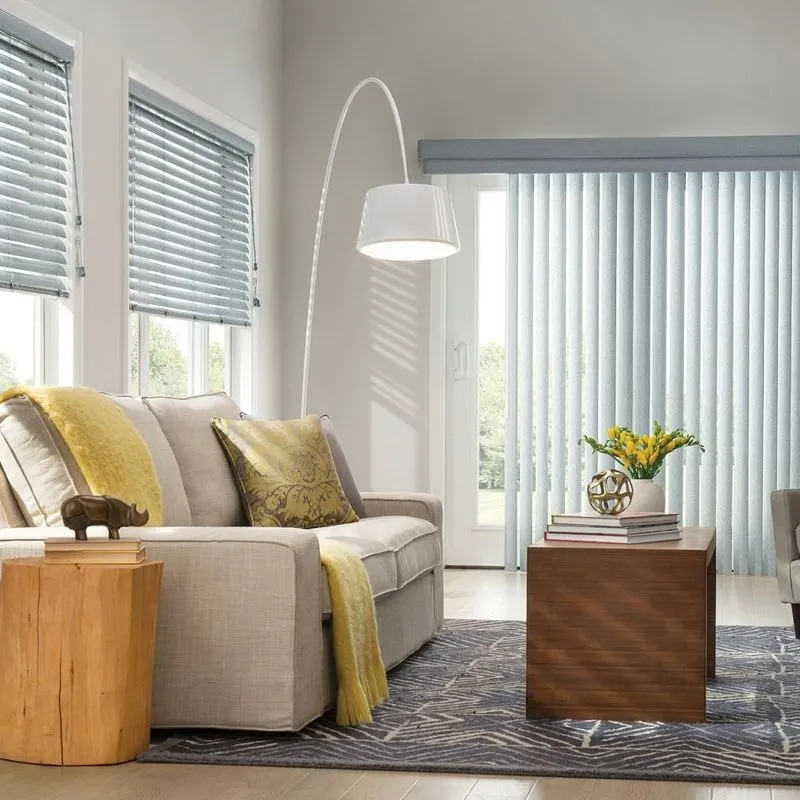 Gray horizontal blinds on windows and vertical blinds on a sliding door in a living room