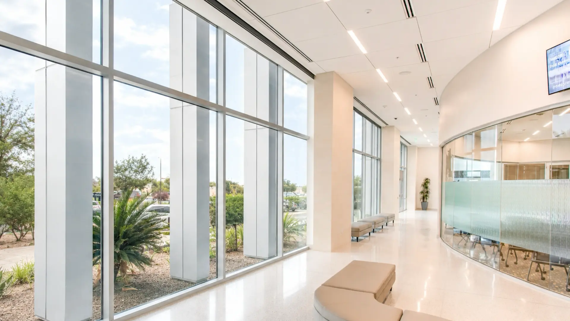 Commercial lobby with bare floor-to-ceiling windows, before installing shades