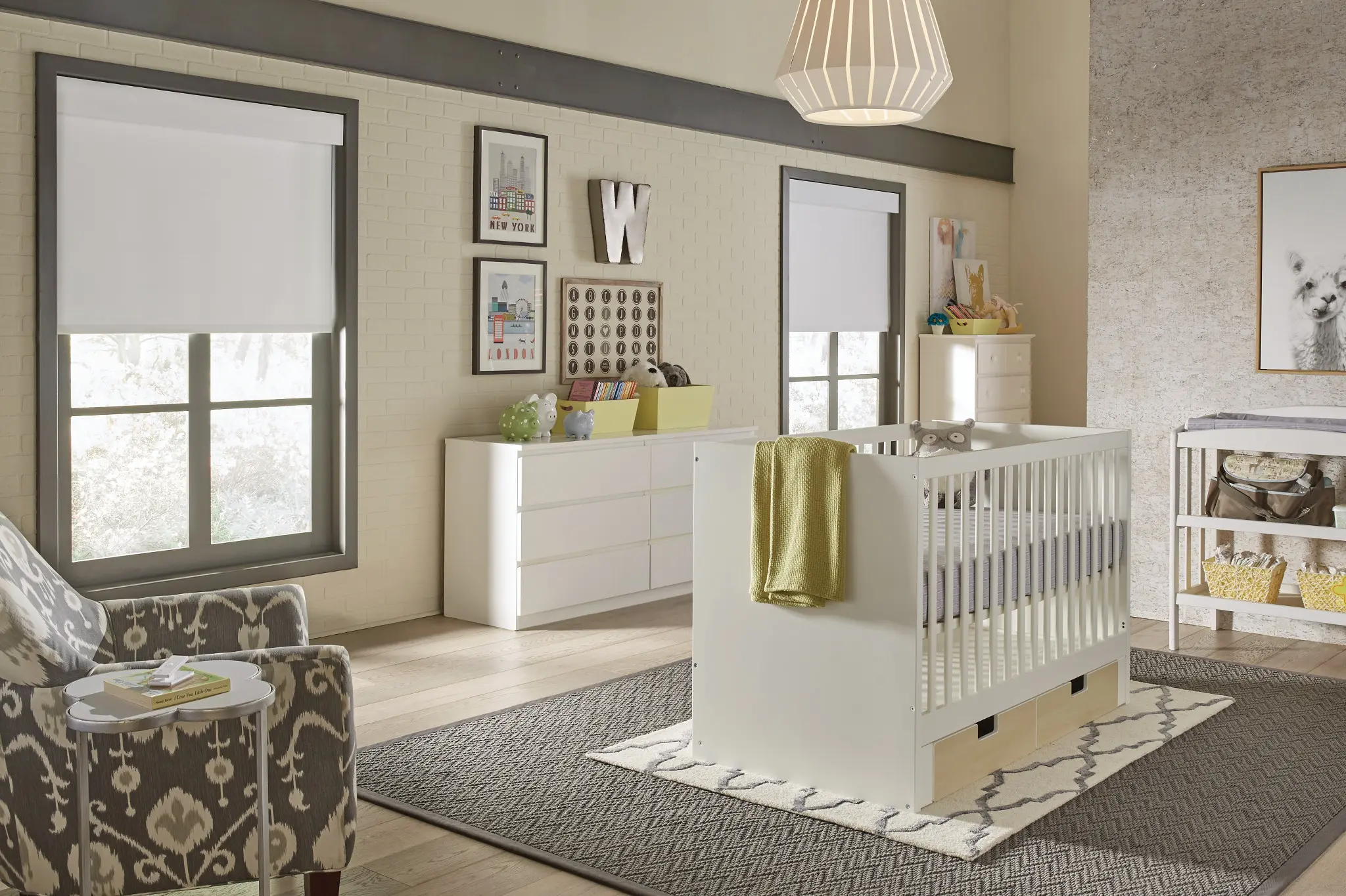 Nursery with white blackout roller shades on gray-framed windows
