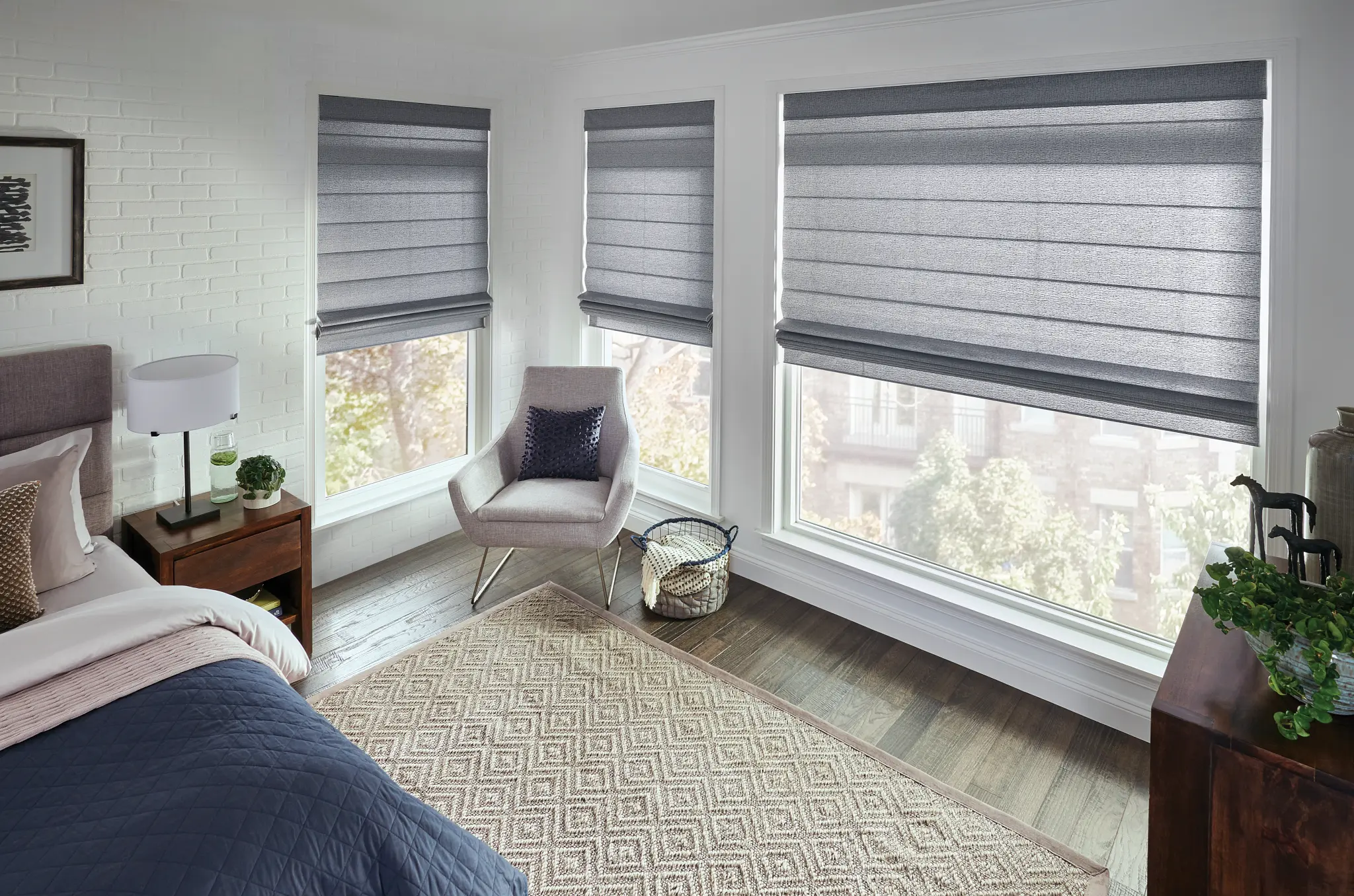 Gray classic Roman shades on bedroom corner windows