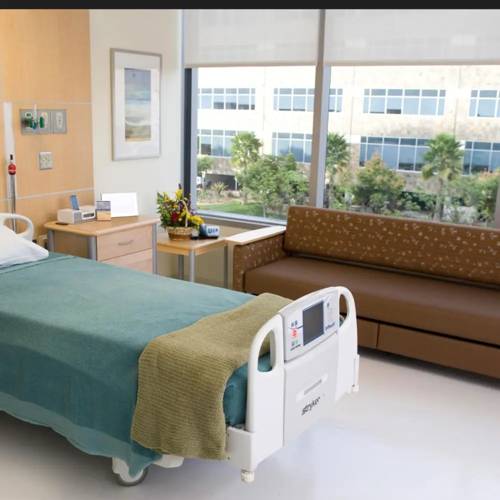 Roller shades on large windows in a hospital patient room