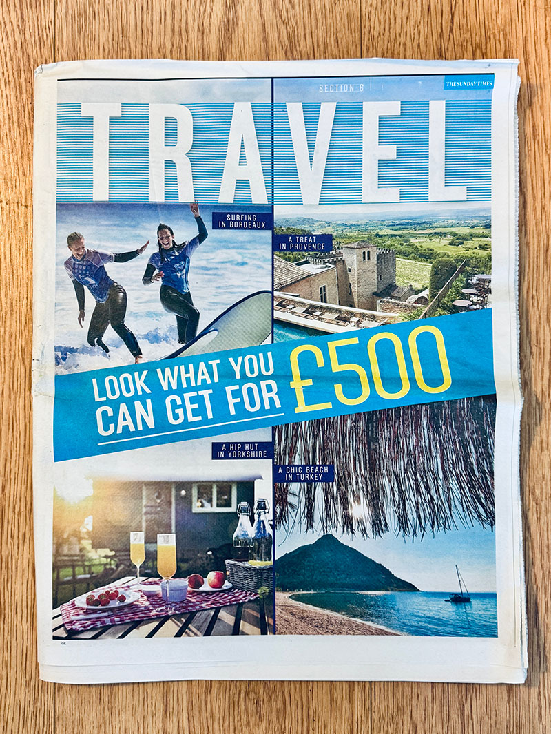 The Sunday Times Travel section cover showing surfing, Provence, Yorkshire hut, and a Turkish beach under £500.