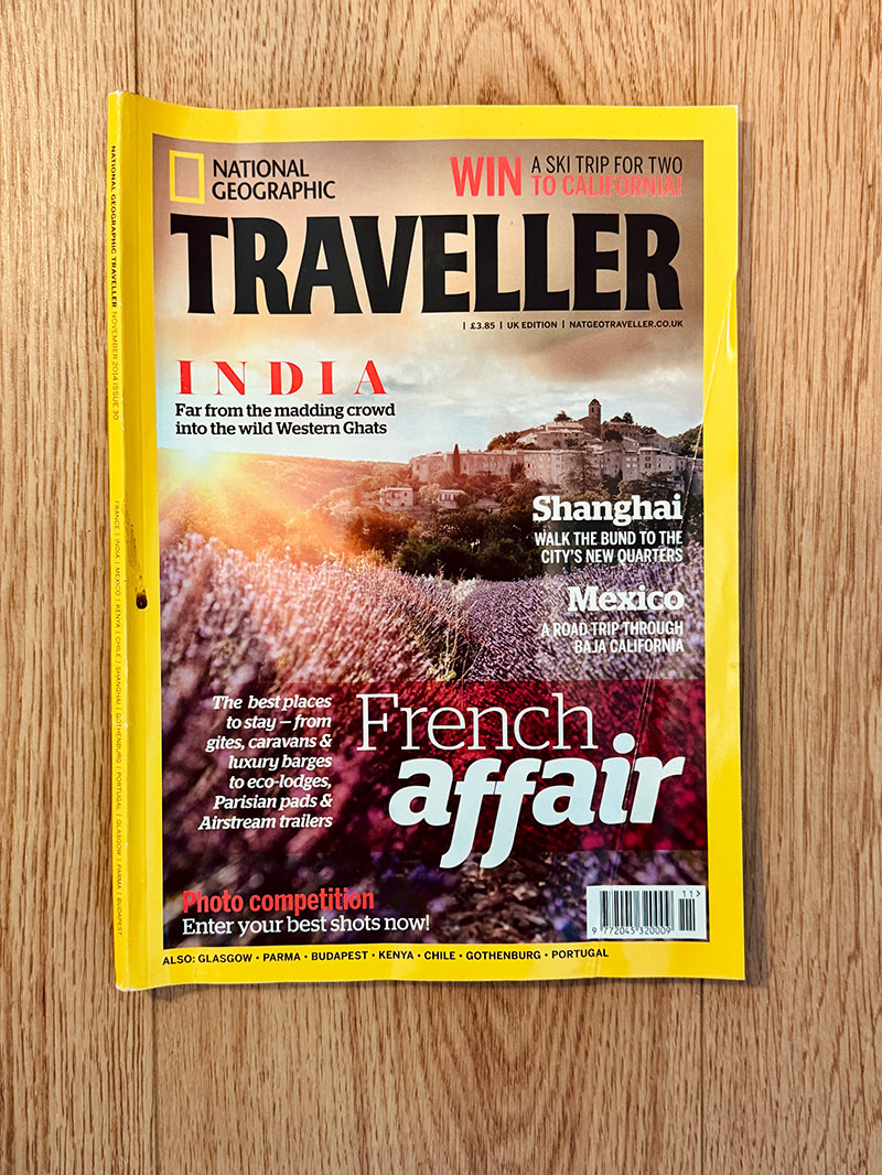 National Geographic Traveller magazine cover featuring a lavender field and hilltop village in France.
