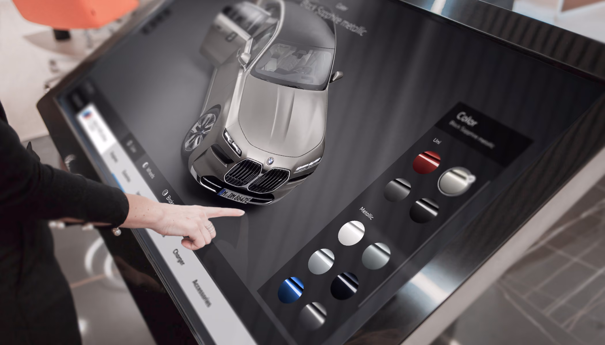 Customer selects a BMW color in a 3D configurator on a large touchscreen.