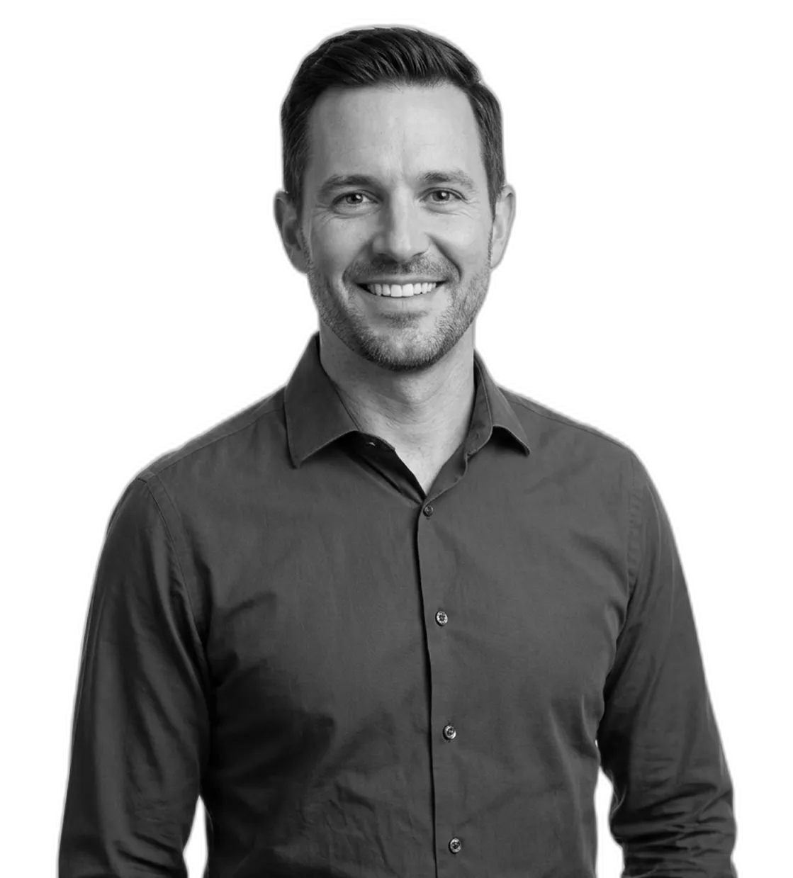 Smiling man with short hair and beard wearing a buttoned-up shirt against a black background.