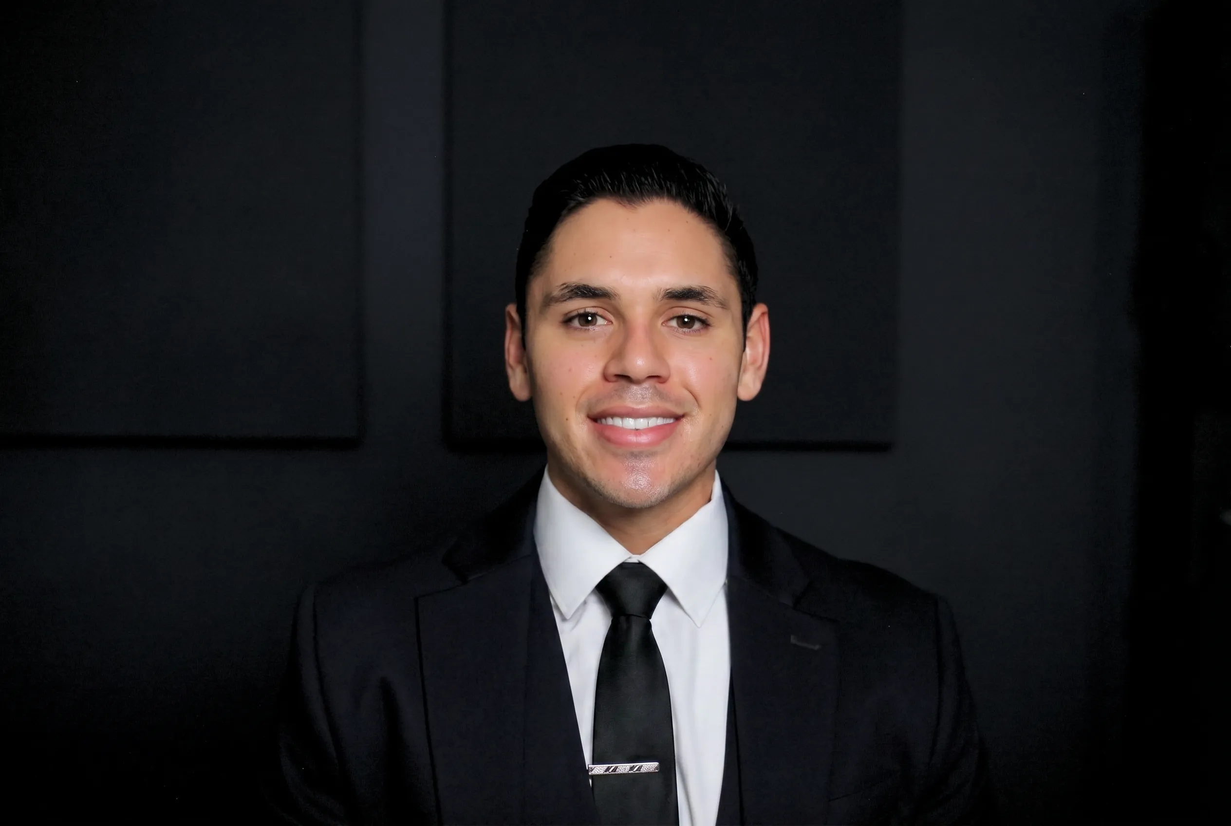 Portrait of attorney Edon Saiyag in a black suit and tie