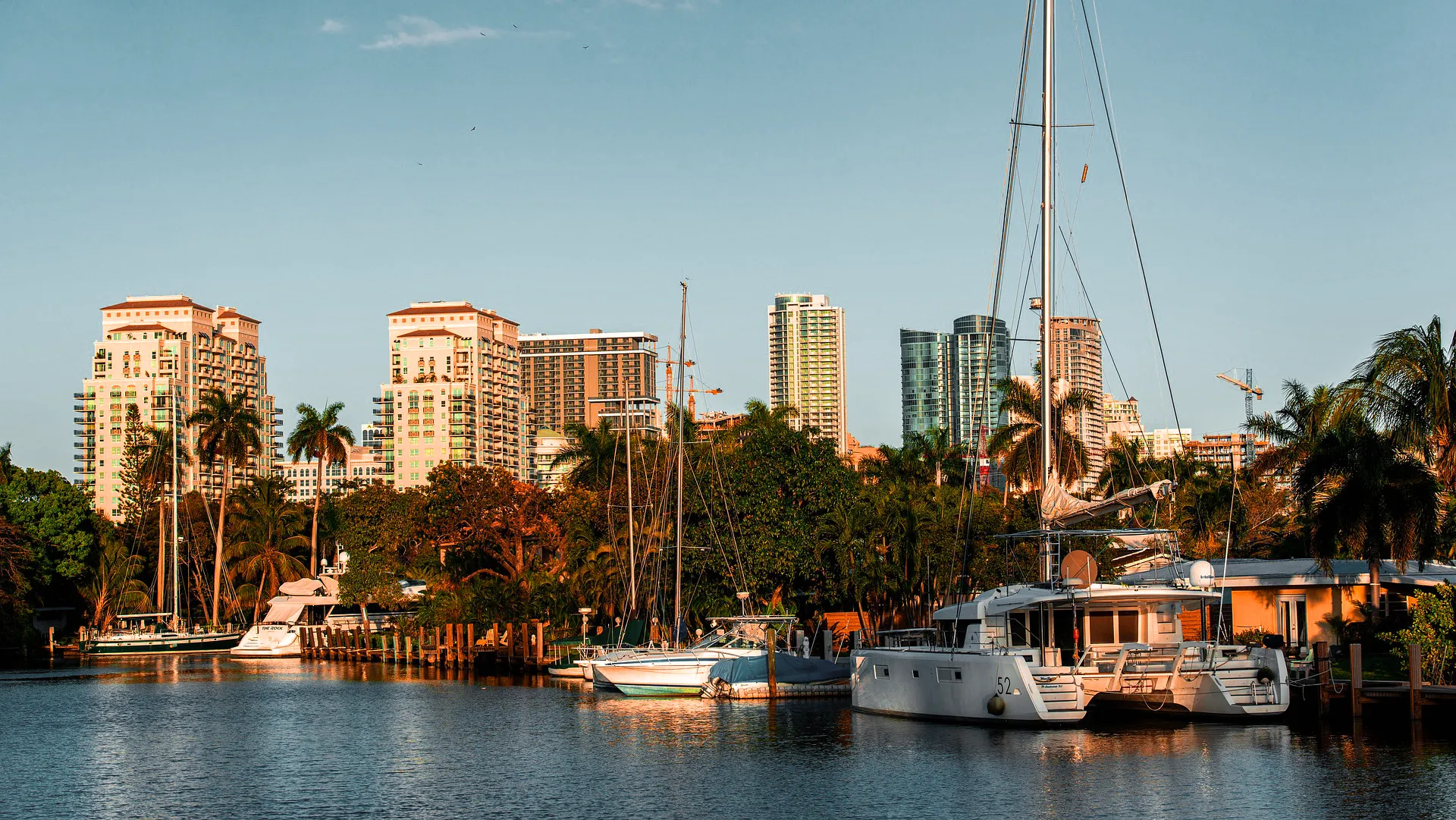 Boats docked at a Broward County marina with the skyline beyond