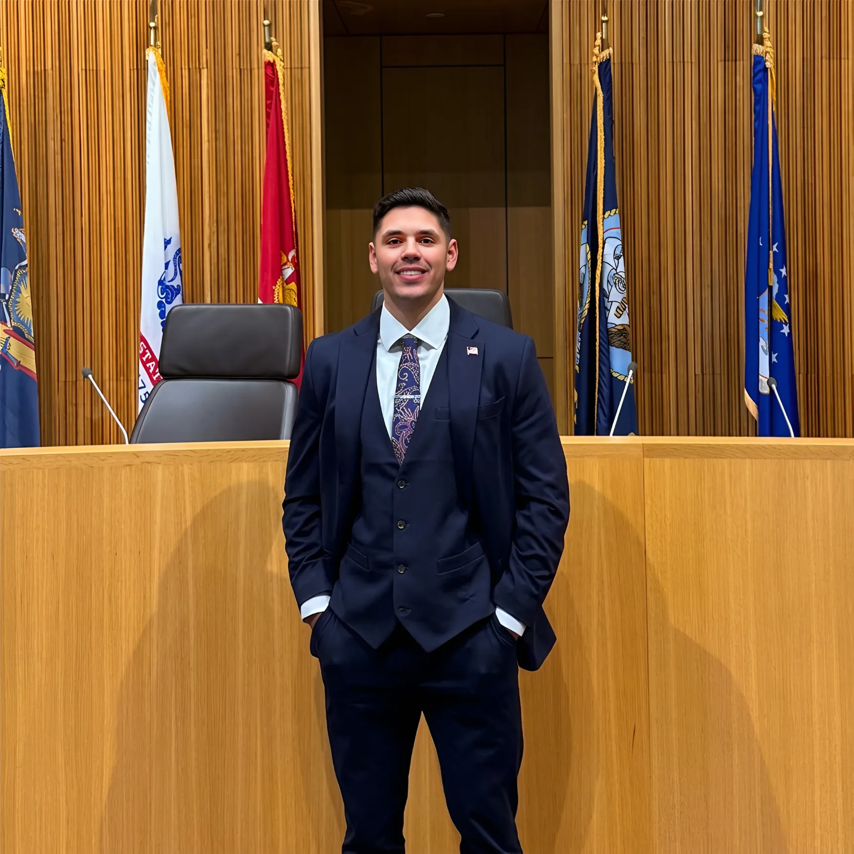 Portrait of attorney Edon Saiyag in a suit and tie in a courtroom