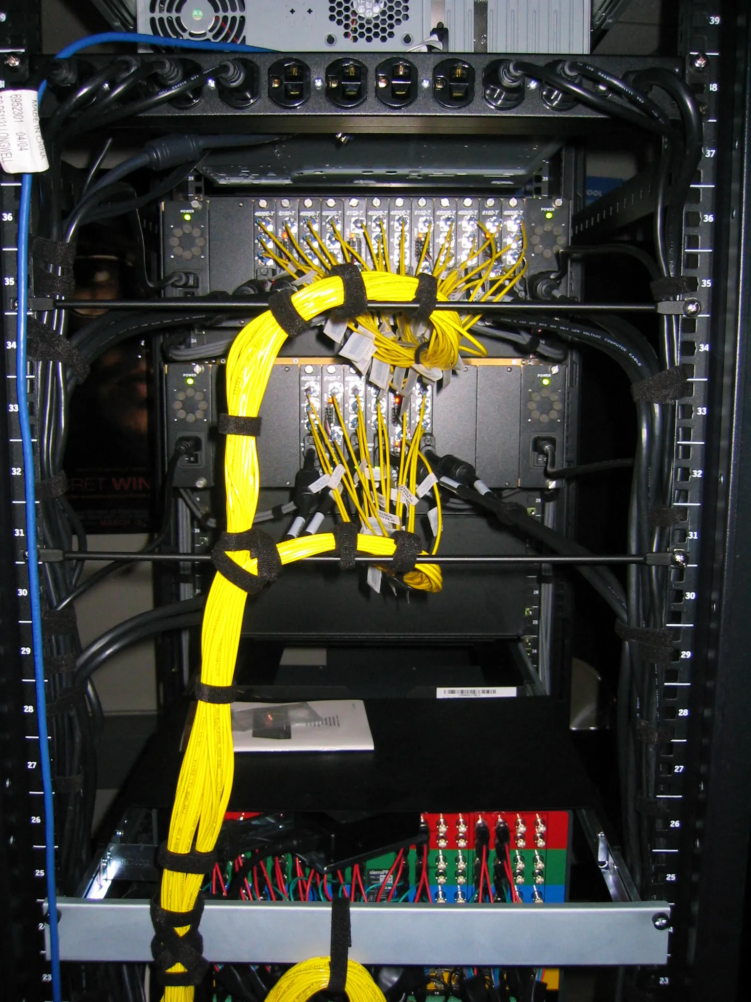 Fiber optic connections and patch panels inside a business network rack
