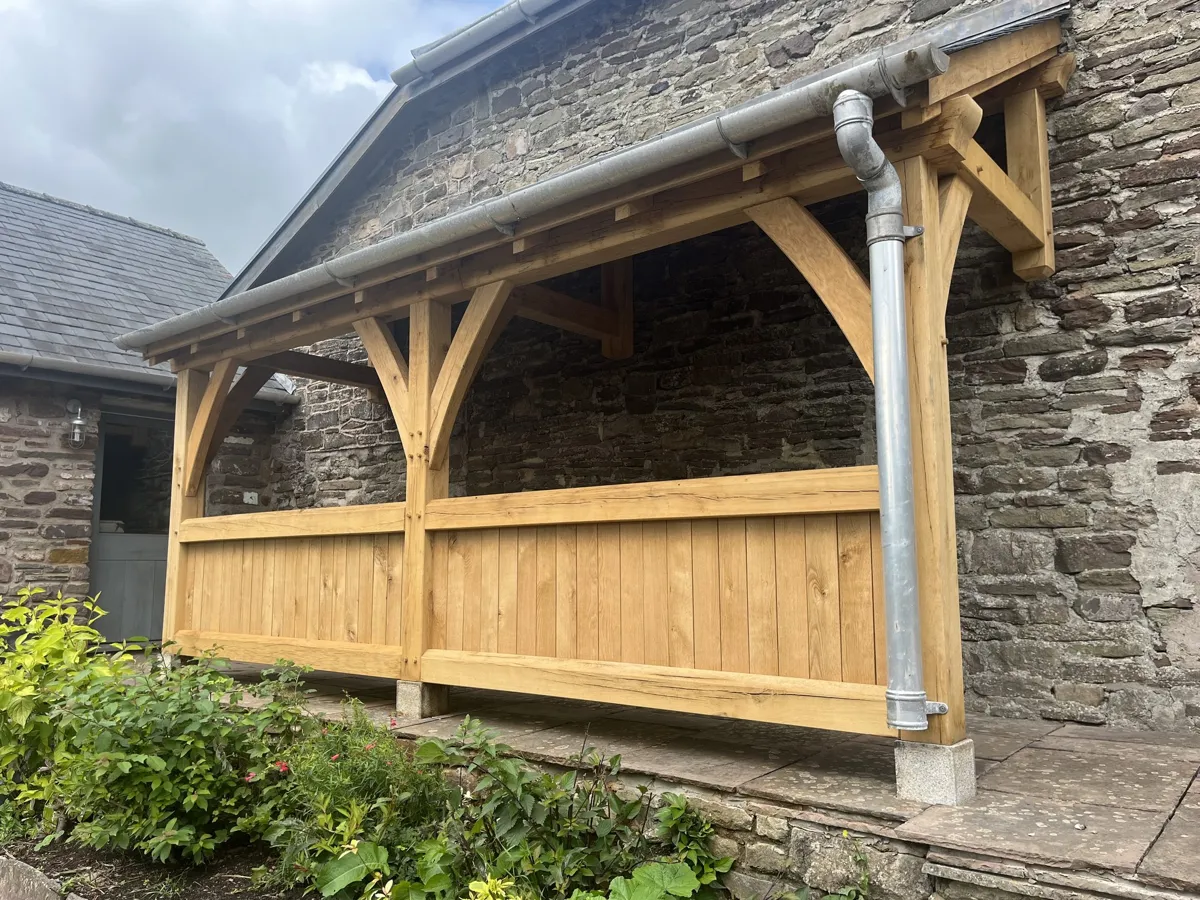 The oak veranda at Llanvetherine at an angle, with its slate roof