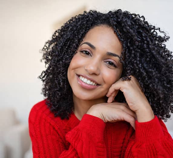 Confident woman smiling warmly at the camera