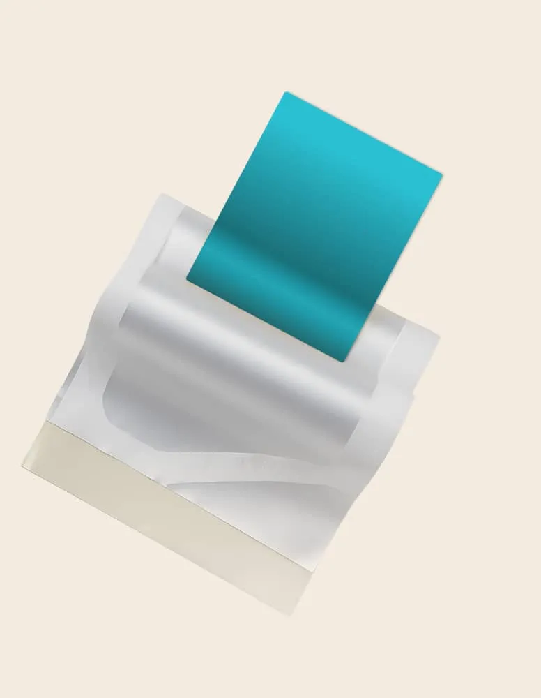 Opened packet of moist towelettes with one teal wipe partially pulled out on a beige background.